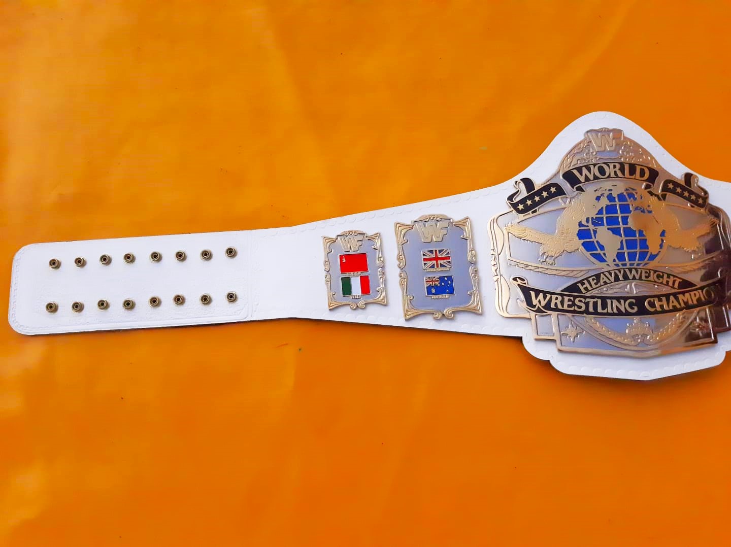 Wrestling championship belt with flags on an orange background